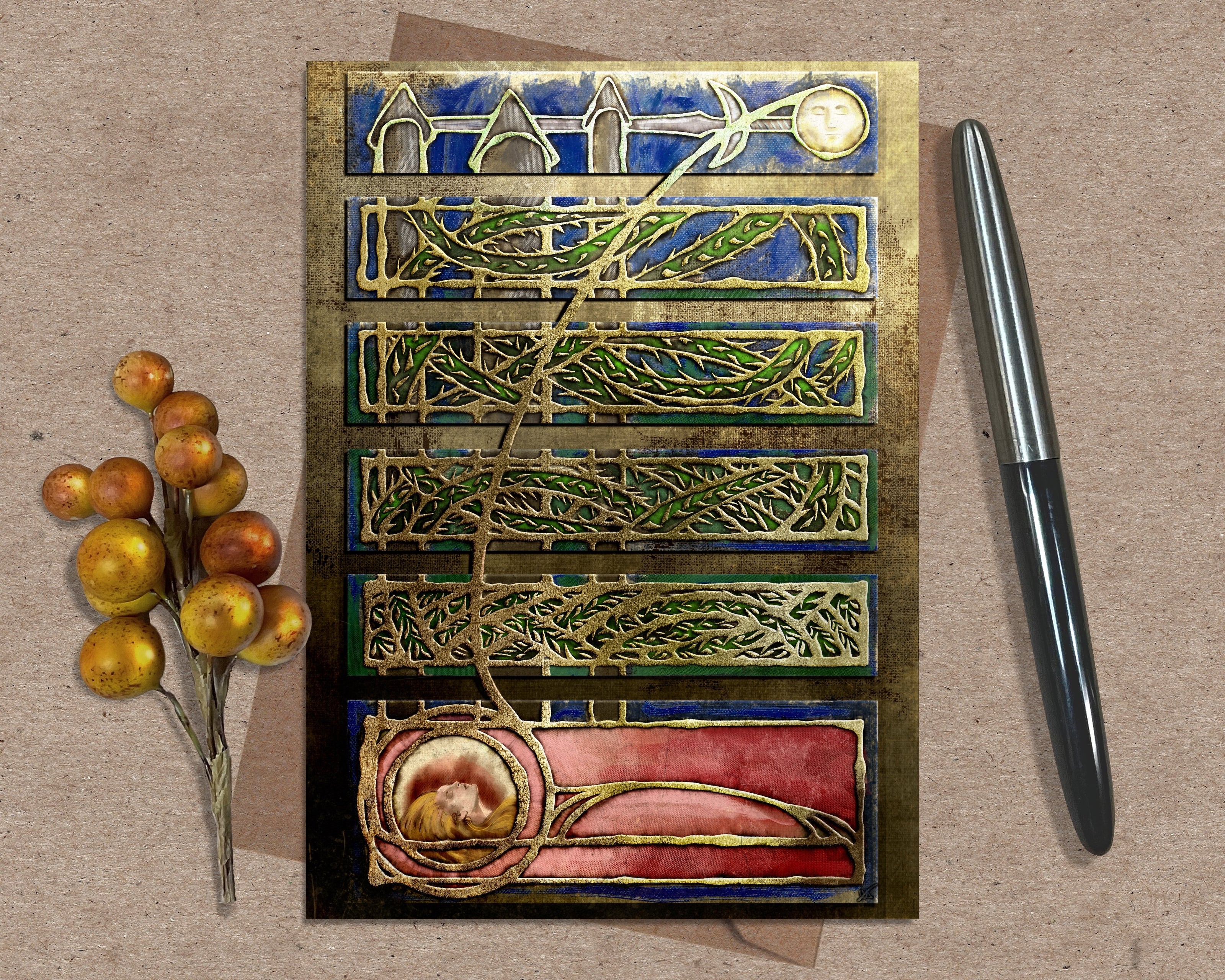 Decorative letterpress printing block with artistic design on a textured surface with a pen and berries.