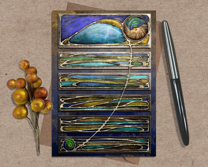 Decorative card with artistic design on a textured surface with a pen and decorative branch.