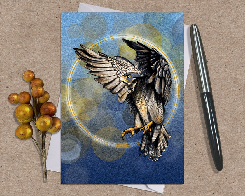 Greeting card with a falcon design on a textured surface with a pen and berries.