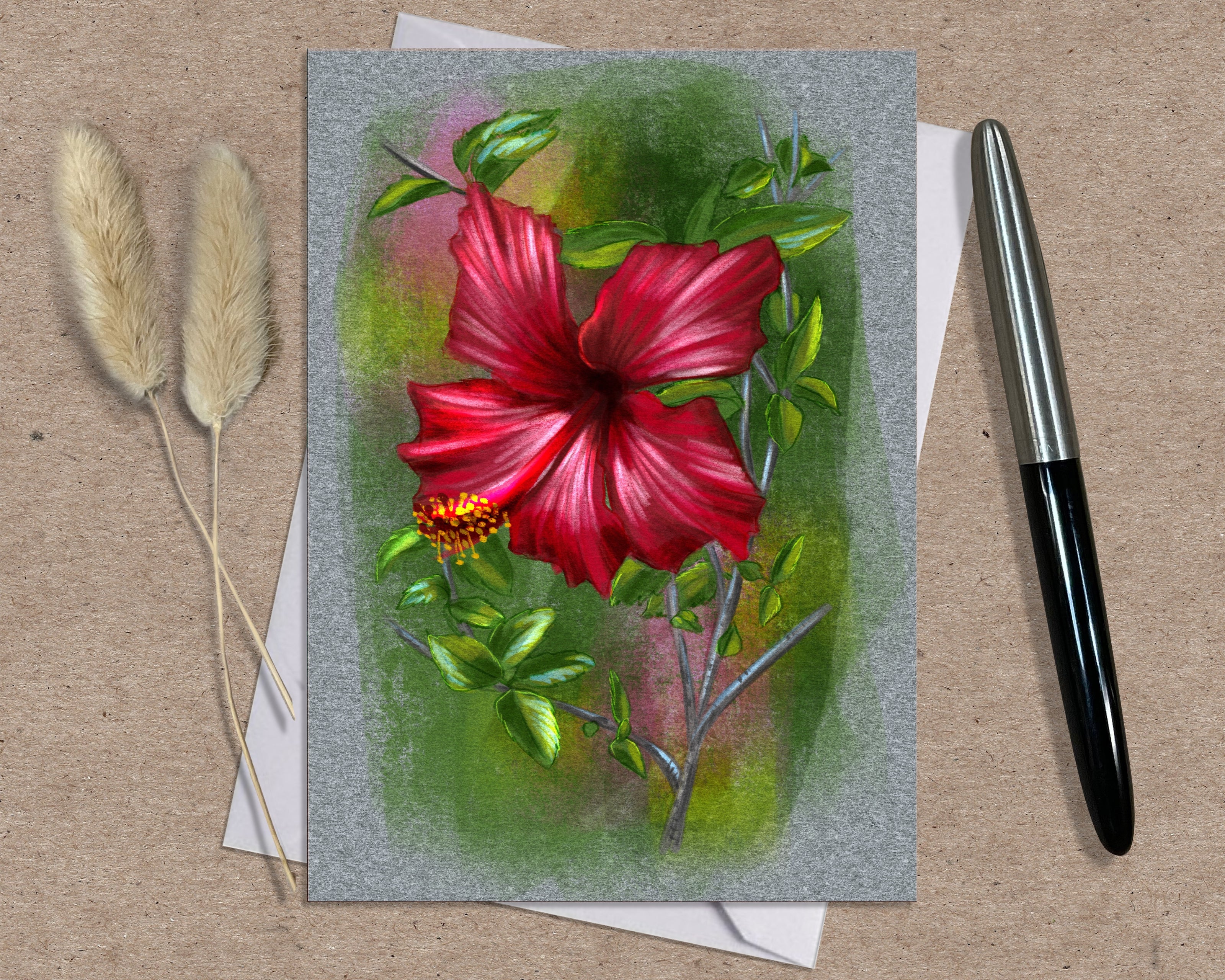 Greeting card with a red flower illustration on a textured surface with a pen and dried plants.