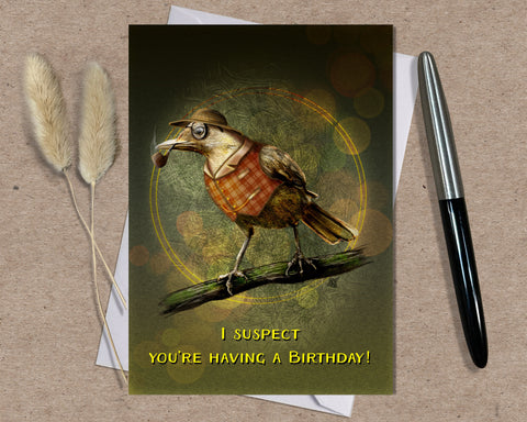 Birthday card with a bird illustration and text on a textured surface with a pen and dried plants. Text on the card says 