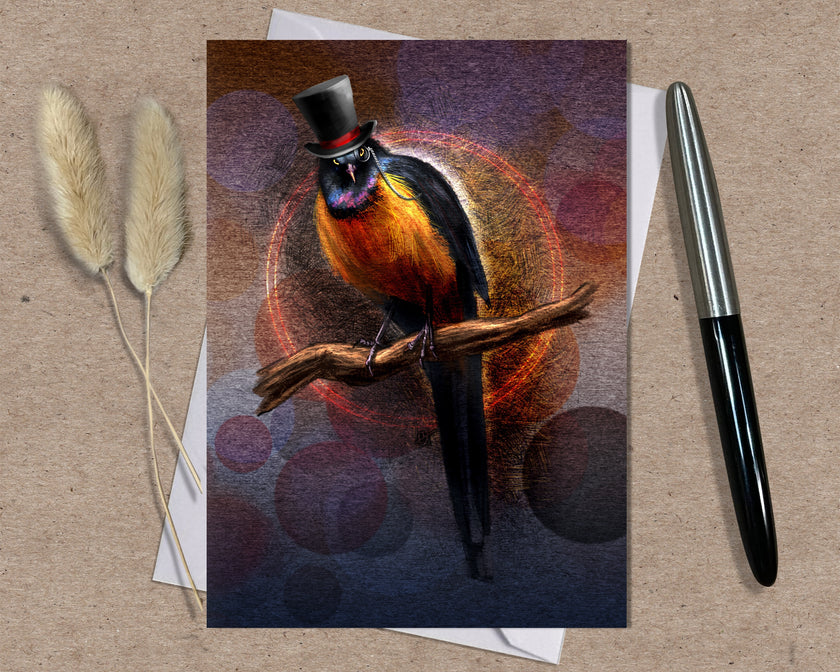 Greeting card with a stylized bird wearing a top hat on a textured surface with a pen and dried plants.