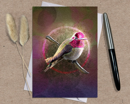 Greeting card with a colorful bird design on a textured surface with a pen and dried plants.