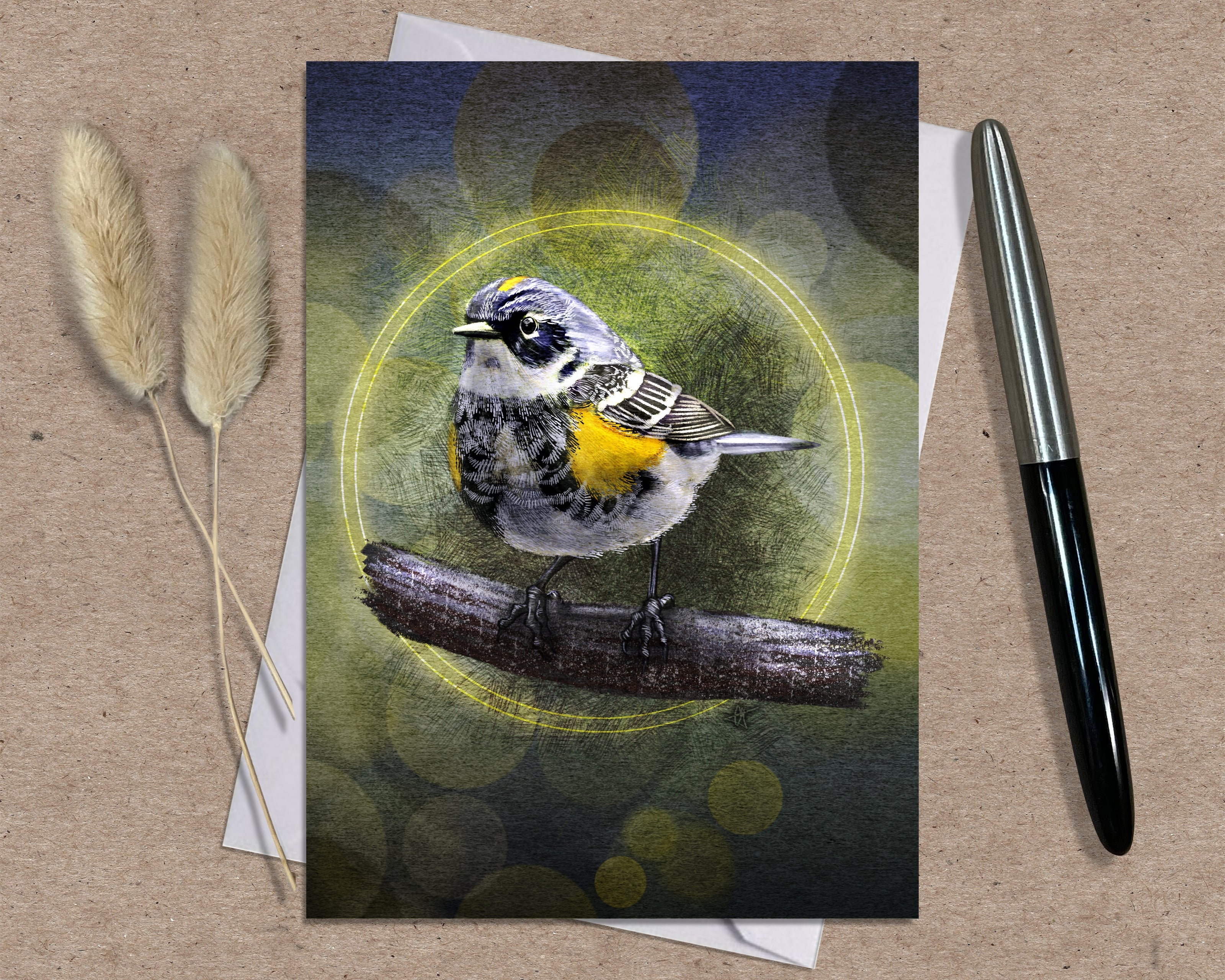 Card with a bird illustration on a textured surface with a pen and dried plants.
